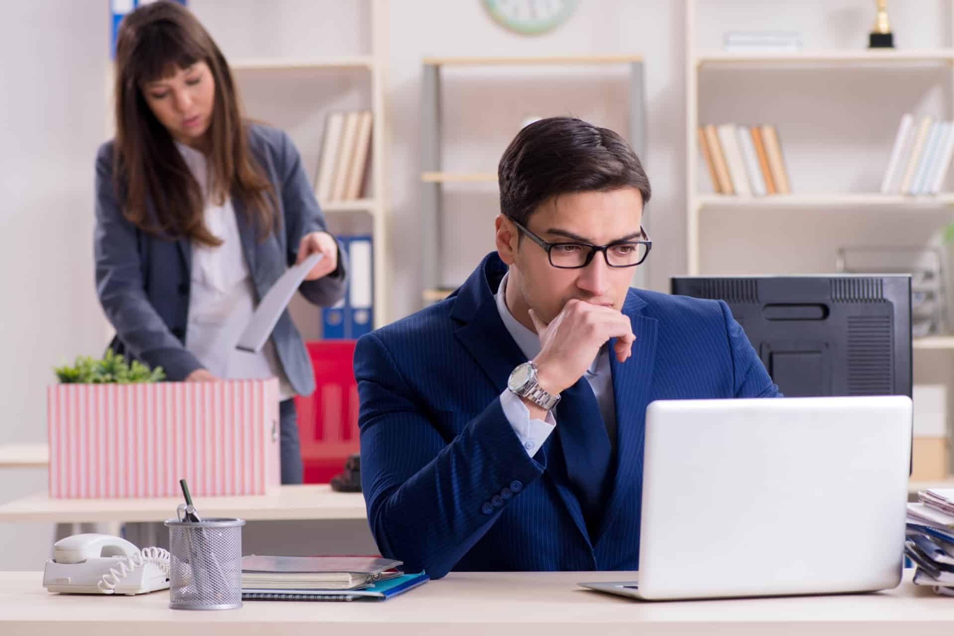 A corporate professional investigating workplace retaliation laws on his laptop