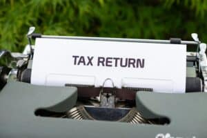 typewriter typing "tax return" - Tax Implications and Golden Parachute Rules